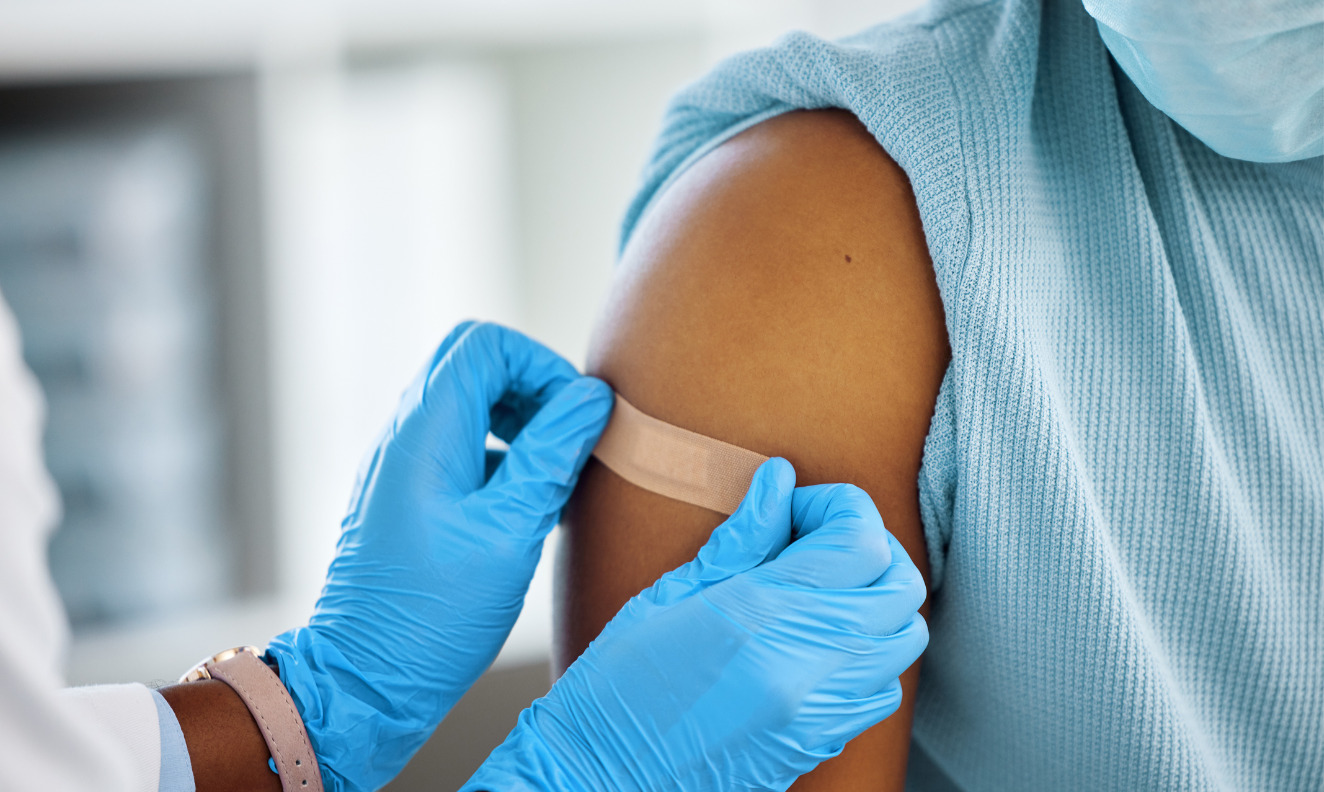 doctor applying a band aid to a patient's arm