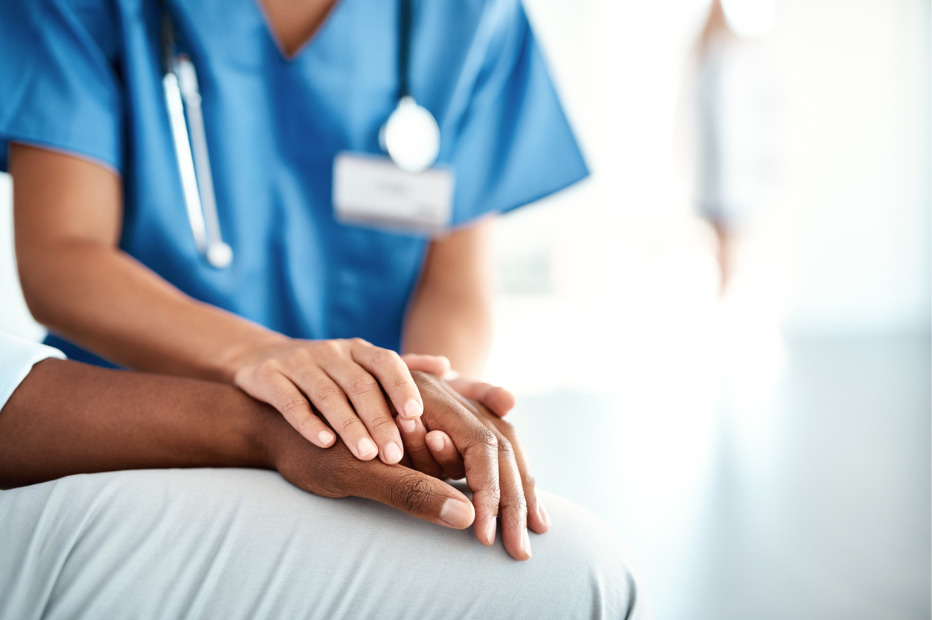 nurse holding a patients hand