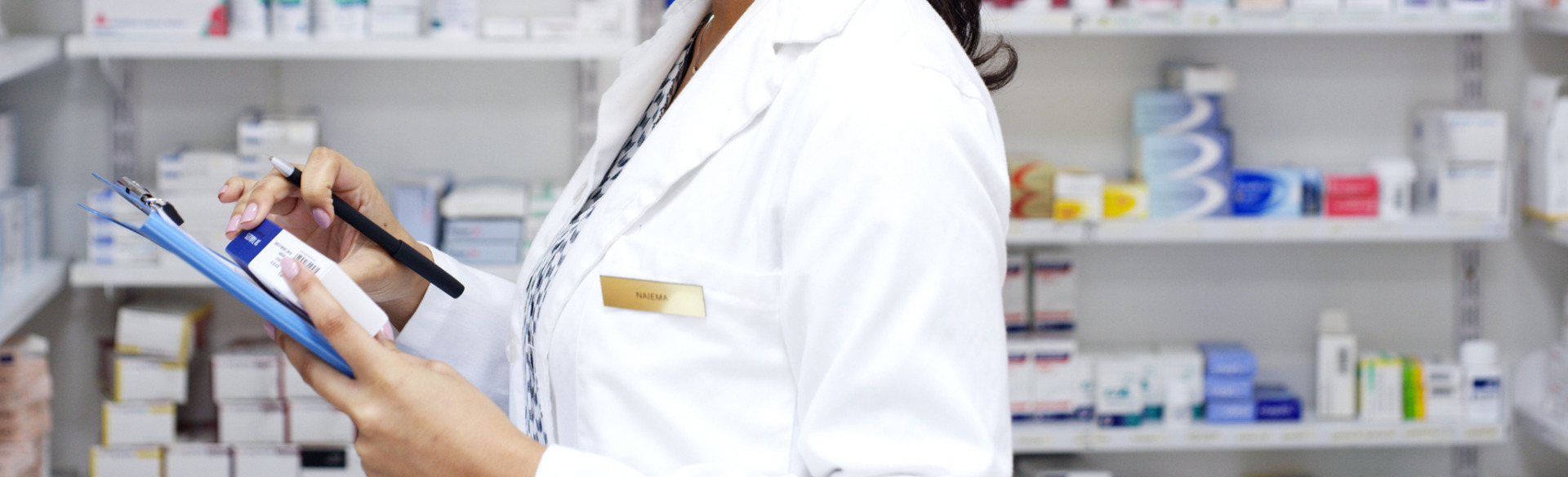 pharmacy technician checking inventory in the pharmacy stock room