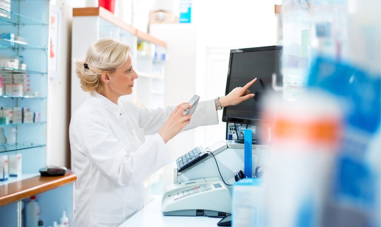 pharmacist looking at drug information on a computer