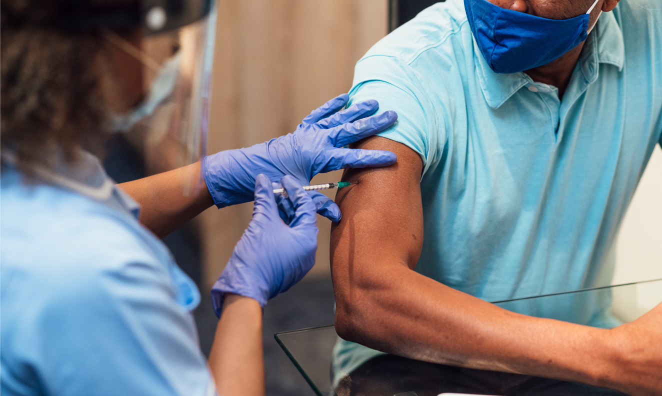 nurse administering a COVID-10 vaccine