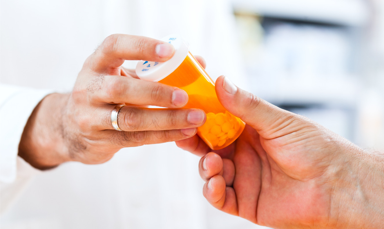 pharmacist giving prescription to a patient
