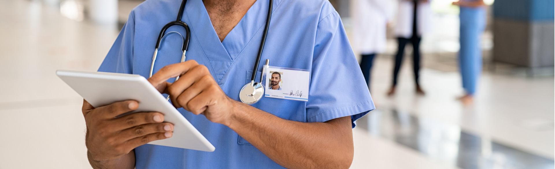 close up of a nurse working on a tablet device in the hospital