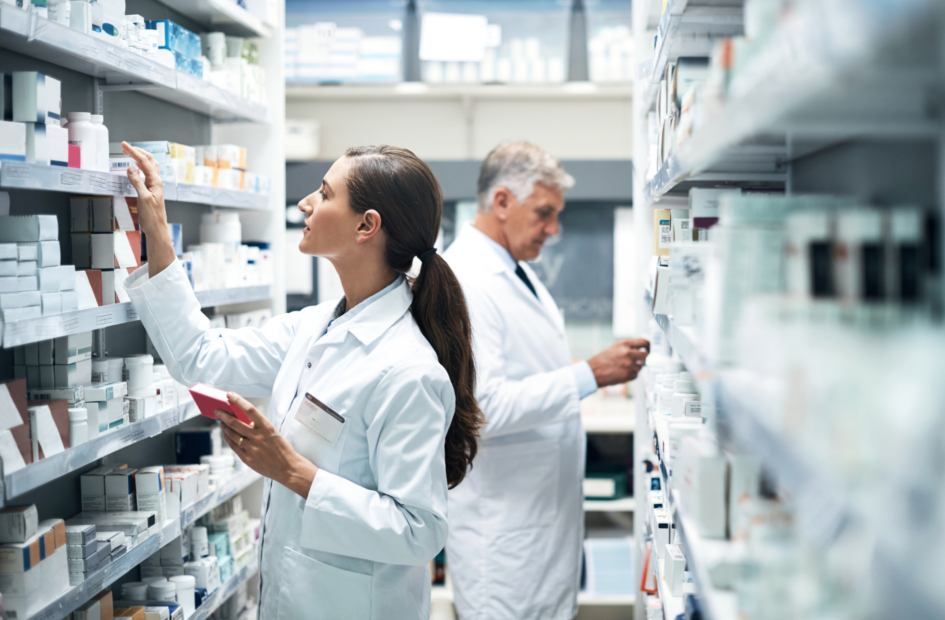 two pharmacists checking medication stock in pharmacy stock room